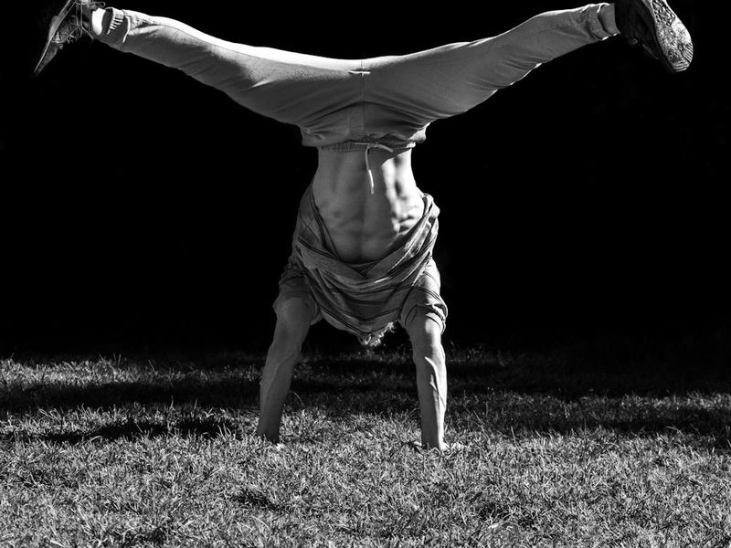 Man in mid-motion during a dynamic bodyweight exercise.